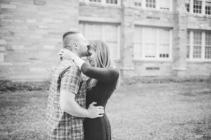 engaged couple kissing hugging west chester university campus proposal